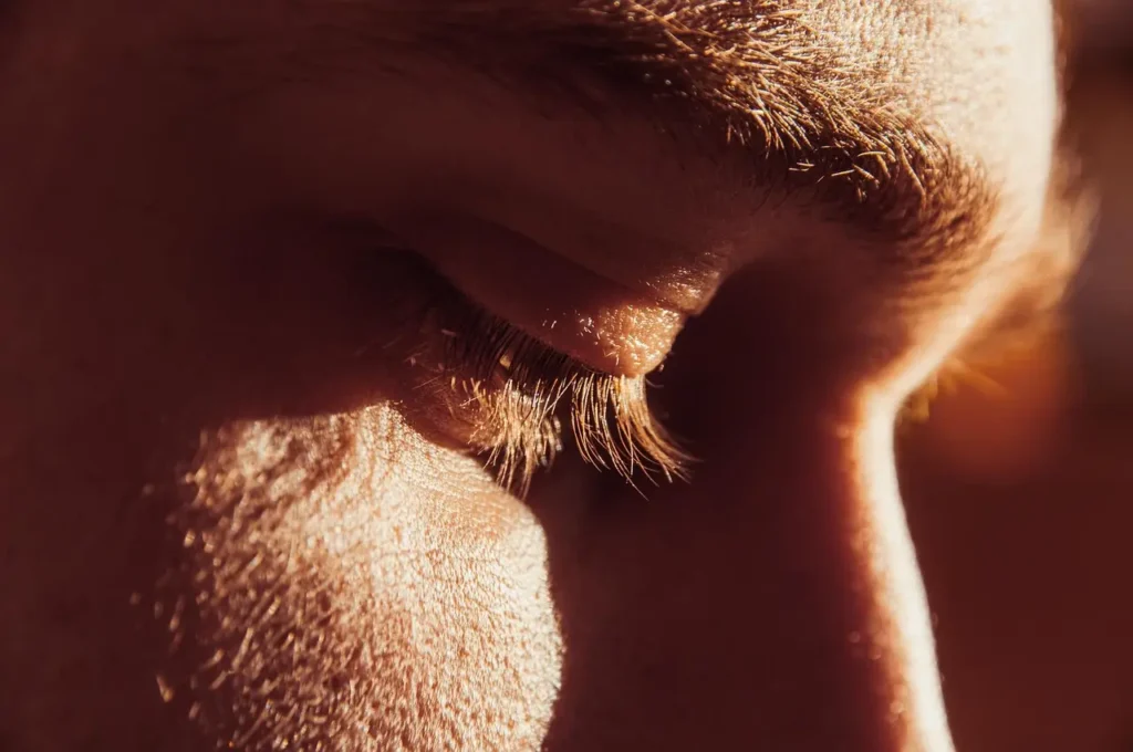 Man looking down reflecting and thinking